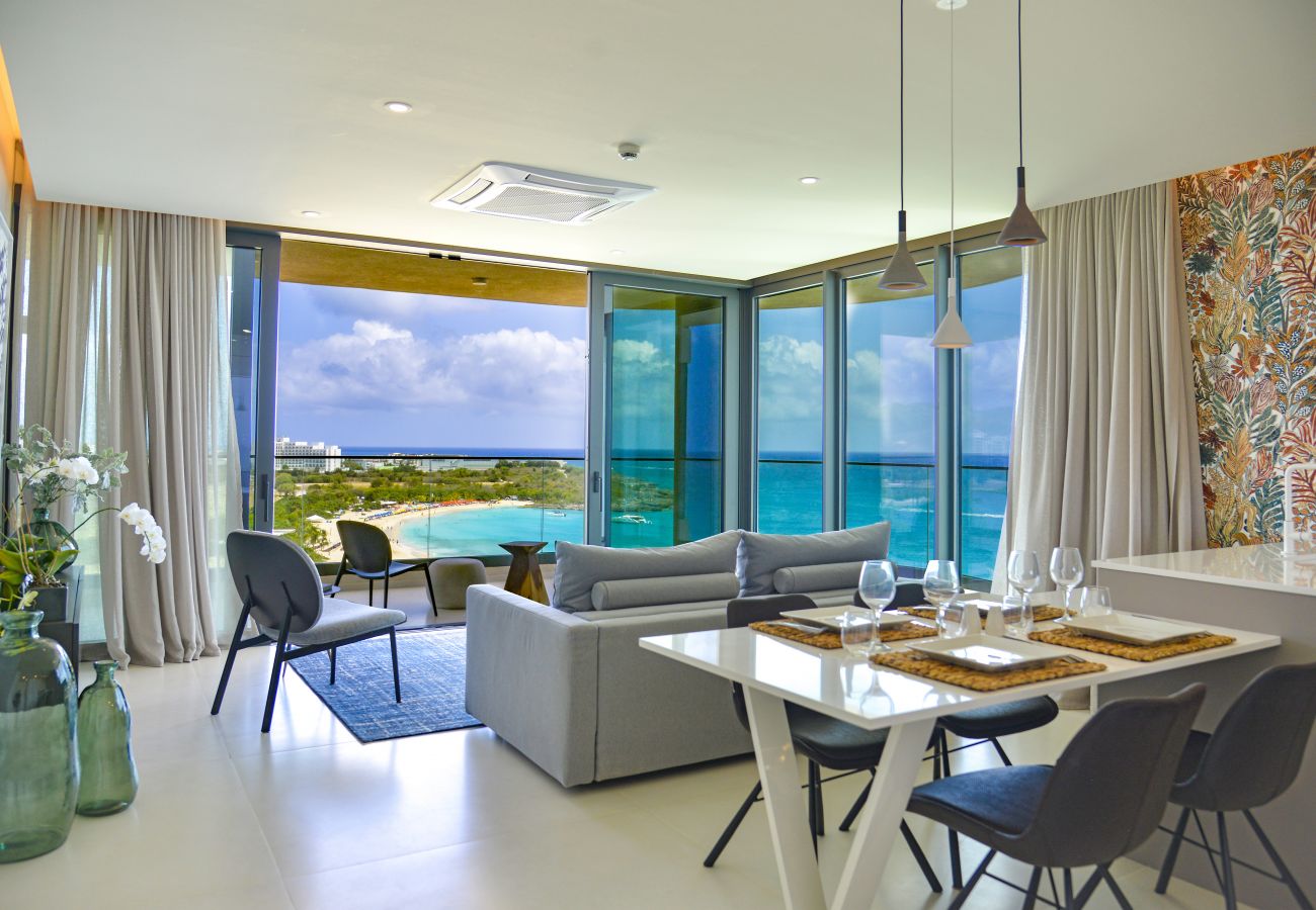Beautiful and spacious living room with open-air concept windows overlooking the turquoise waters